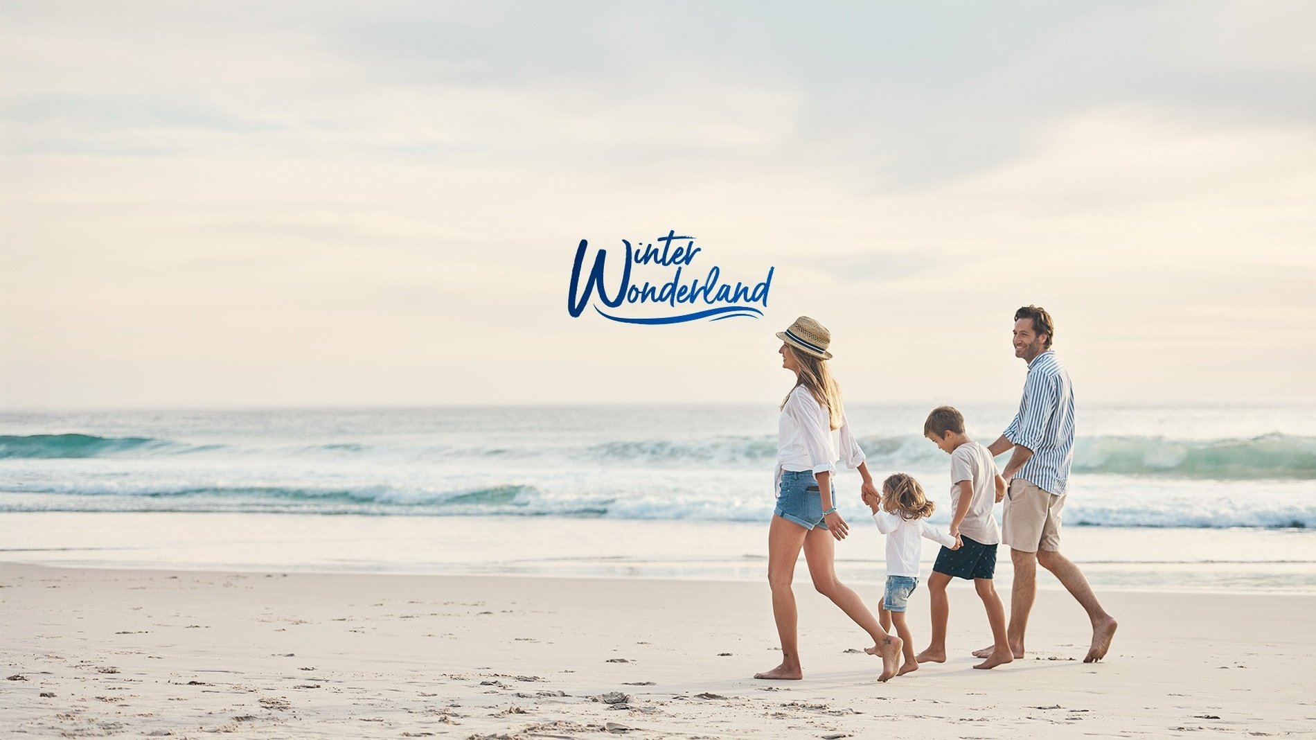 a family walking on the beach with the words winter wonderland behind them