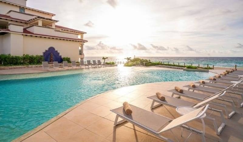 Outdoor pool overlooking the Caribbean Sea at The Villas by Grand Park Royal Cancun