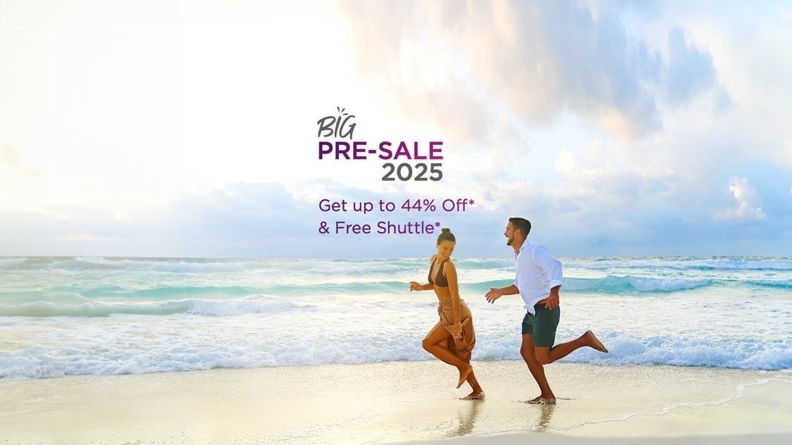 a man and a woman are running on a beach in front of a sign that says big pre-sale 2025