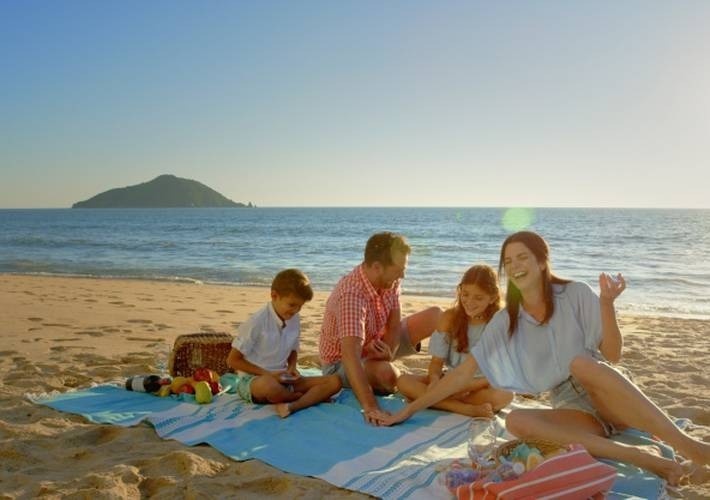 a family is having a picnic on the beach