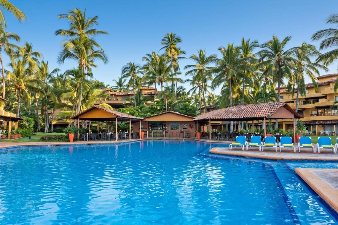 Outdoor pools with hammocks and palm trees of Homestay Los Tules in Mexico