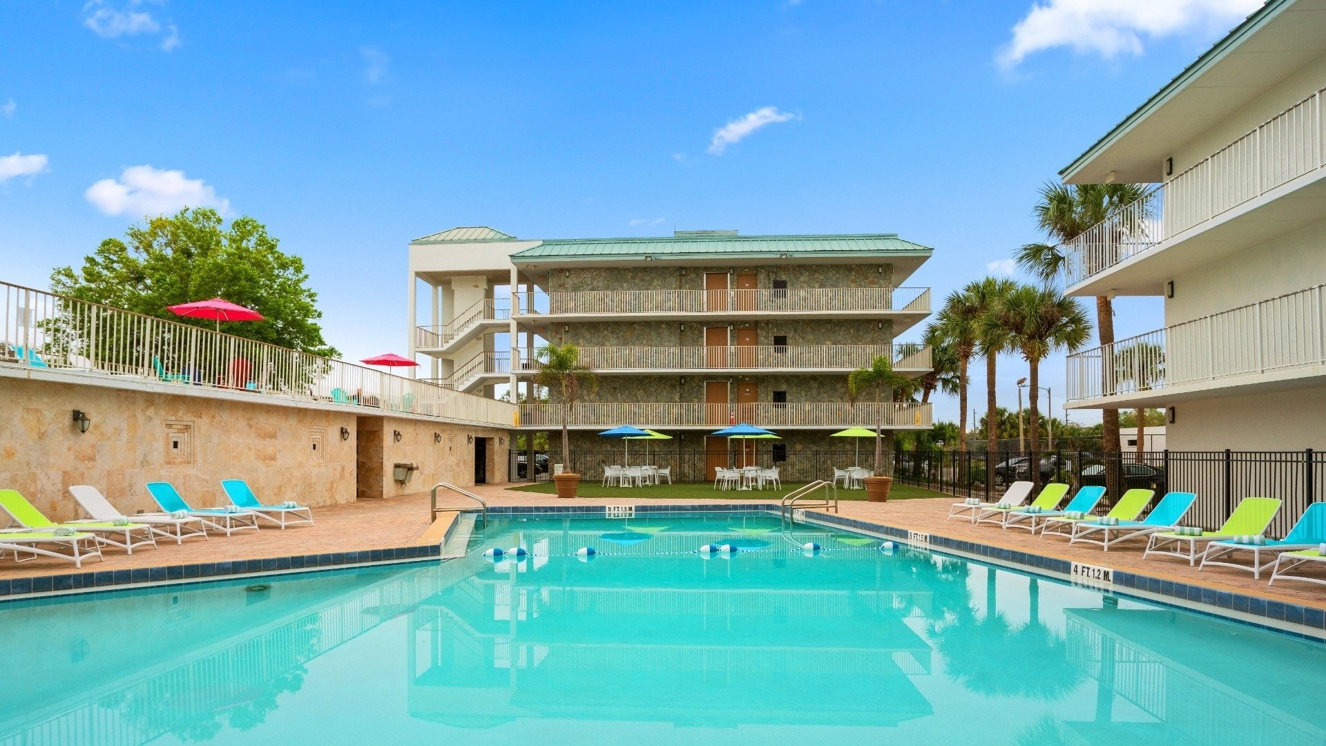 an aerial view of a hotel with tables and chairs and umbrellas