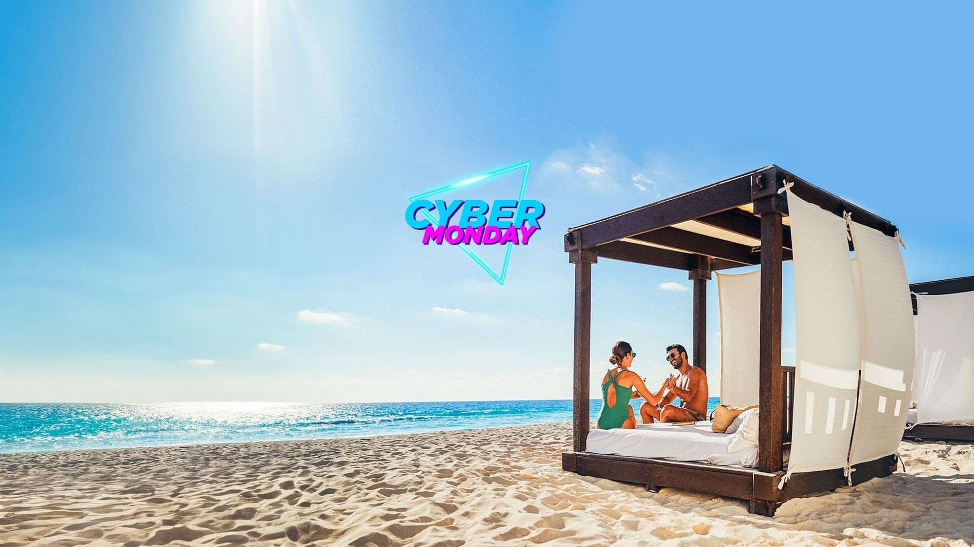 a couple sits in a canopy on the beach with cyber monday in the background