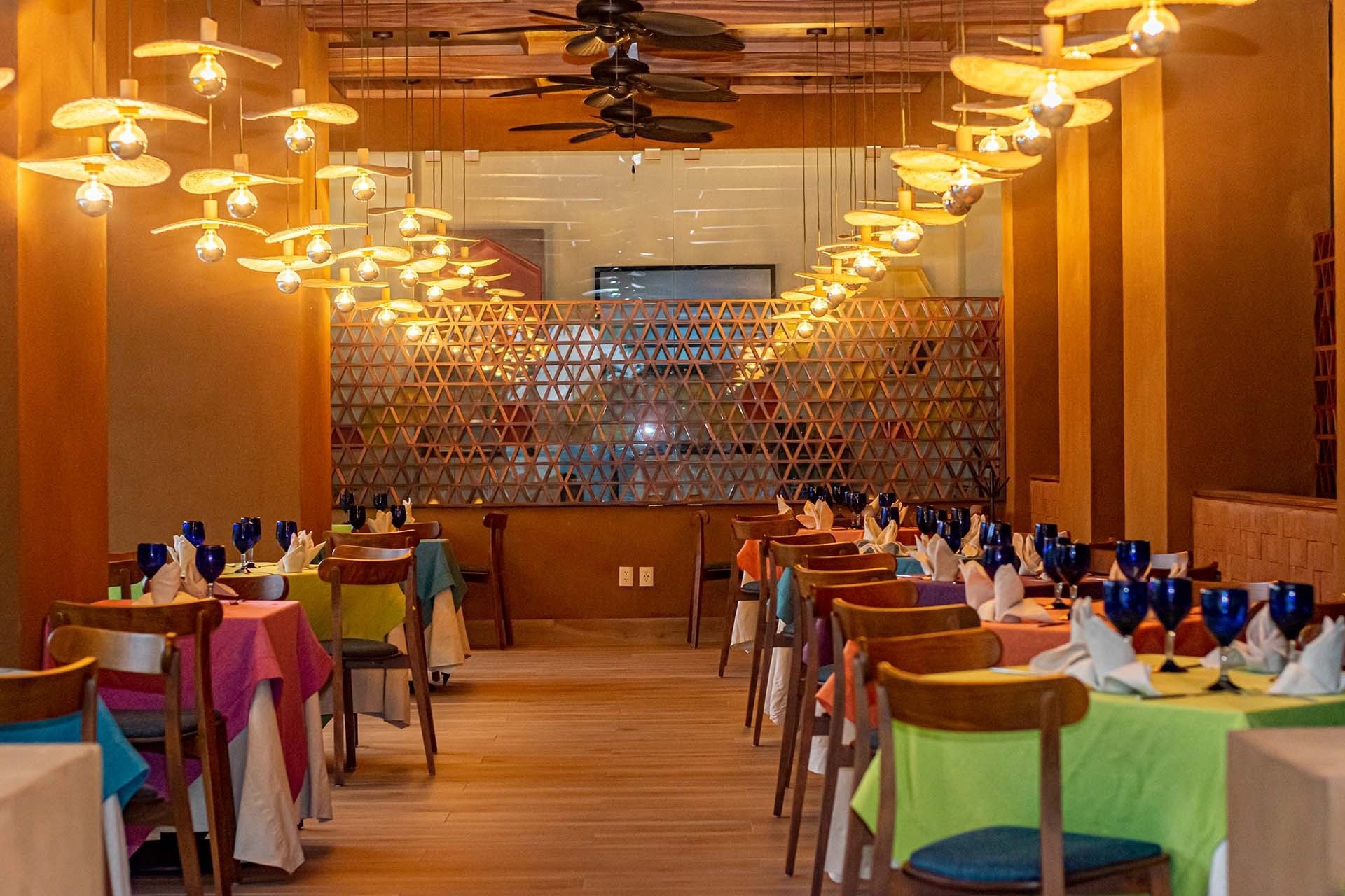 A long row of tables and chairs in one of the Park Royal Huatulco restaurants