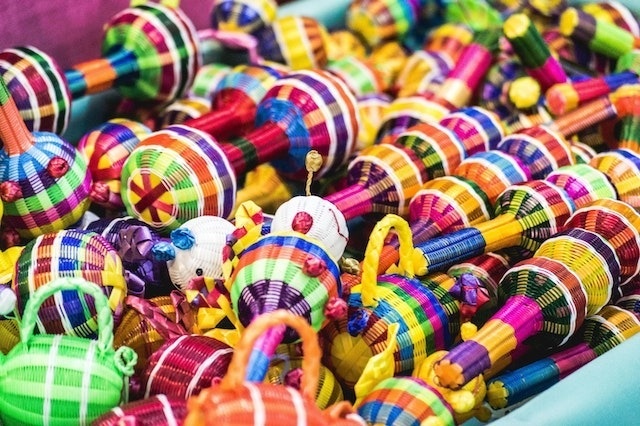 a bunch of colorful maracas are sitting on top of each other on a table .