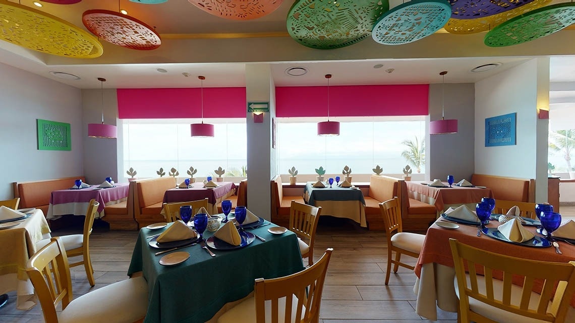 Tables and chairs area of the Frida restaurant of the Hotel Grand Park Royal Puerto Vallarta
