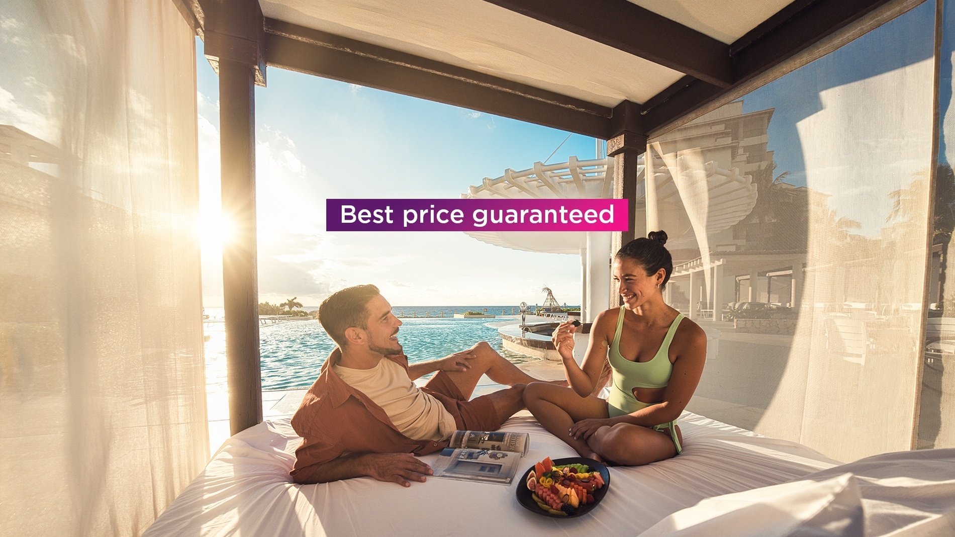 a man and woman sitting on a bed with a sign that says best price guaranteed