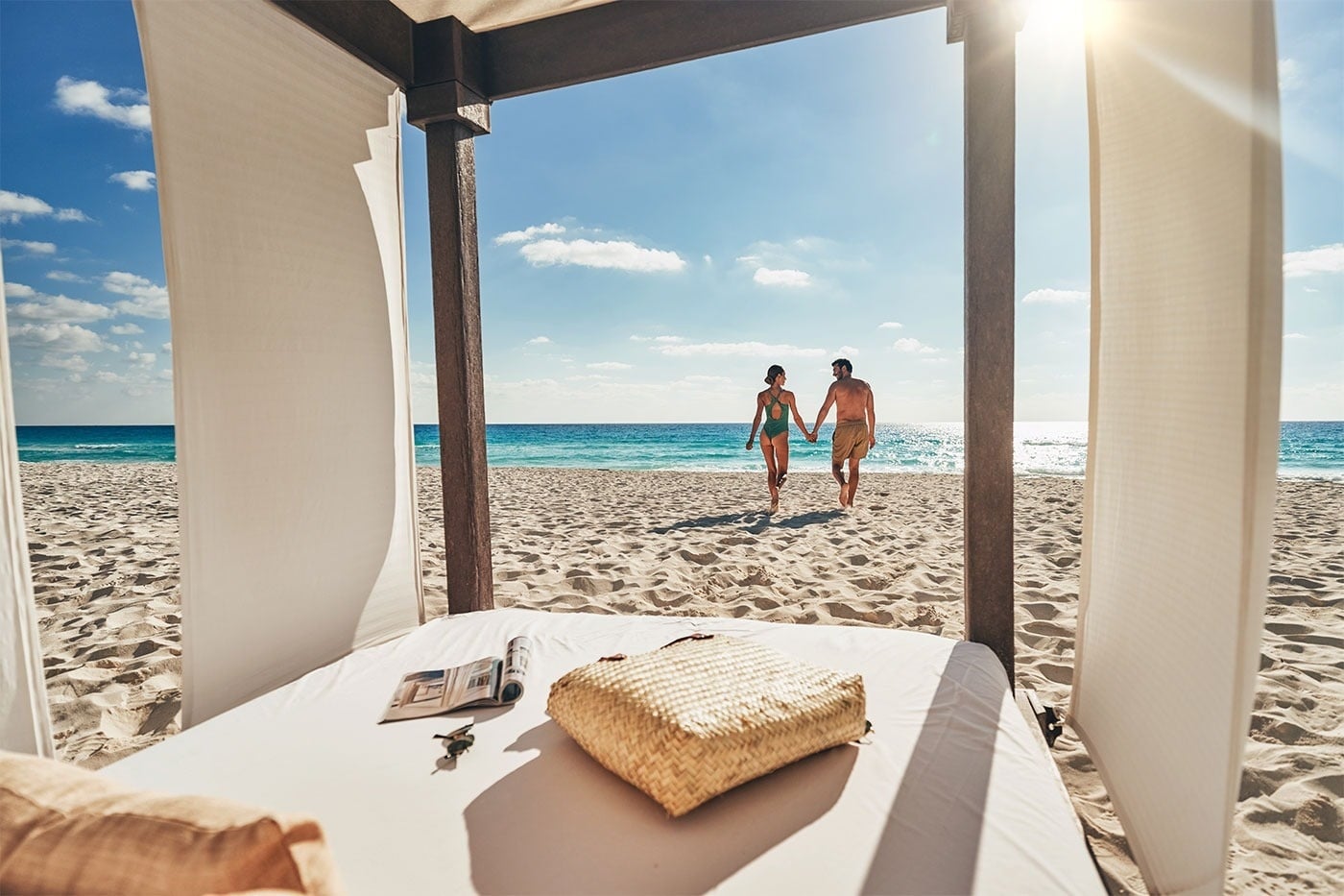 Couple walks on beach at Hotel Grand Park Royal Cancun, Mexican Caribbean.