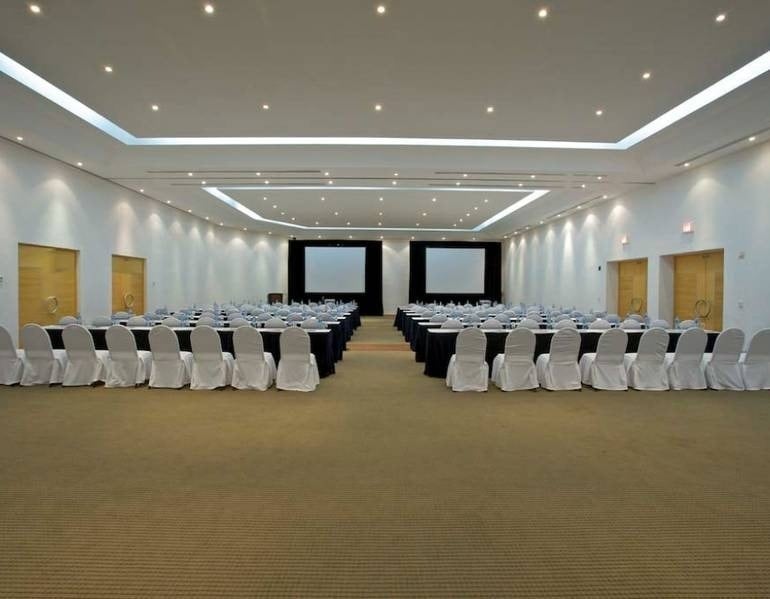 Overview of event room with chairs, lecterns and TV at Park Royal hotels and resorts