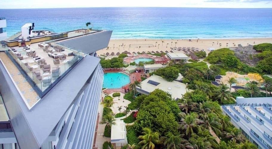 an aerial view of a hotel with a swimming pool