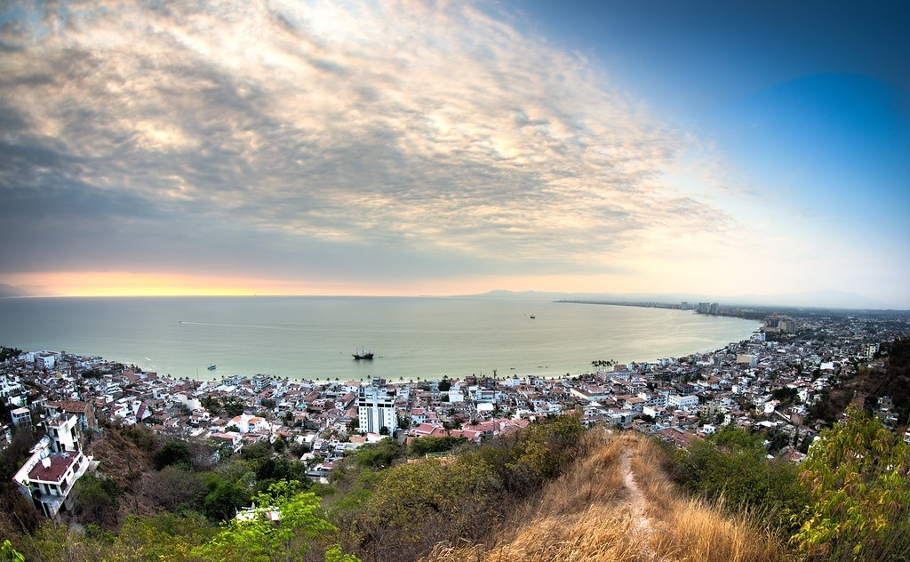 Foto Uma estátua de um cavalo-marinho na frente de um corpo de água –  Imagem de Puerto vallarta