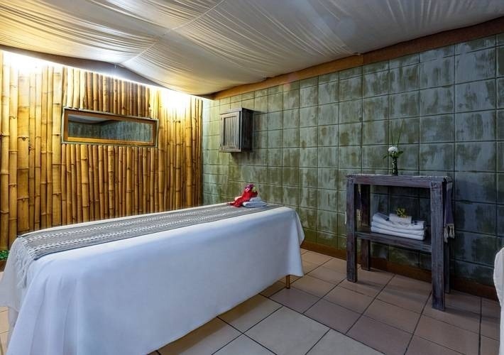 a massage table in a room with bamboo walls