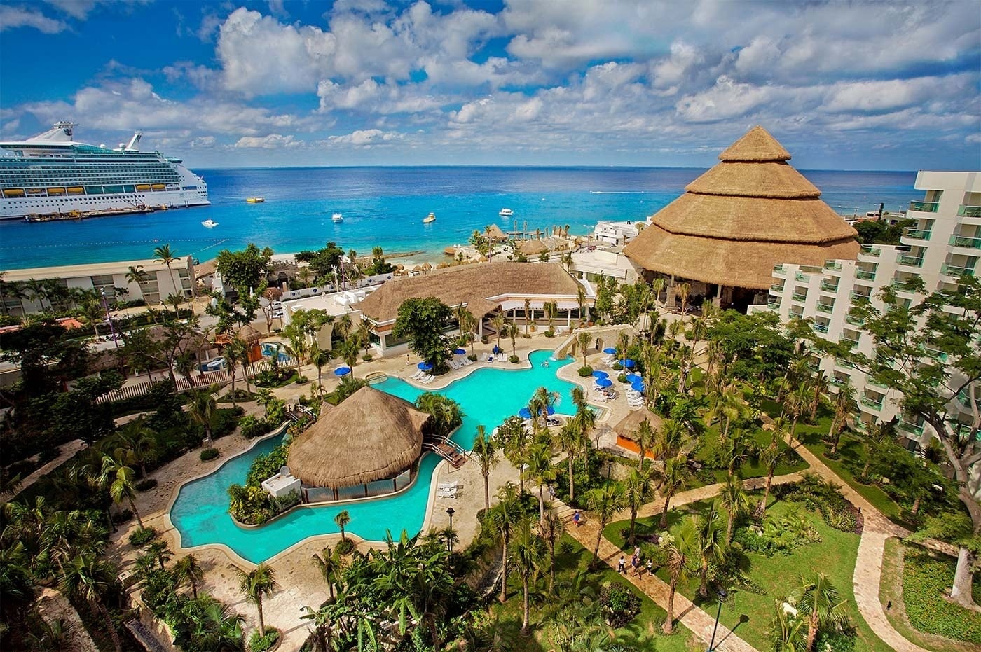 Park Royal Resort: Pool, beach, cruise ship, and palm trees under a blue sky.
