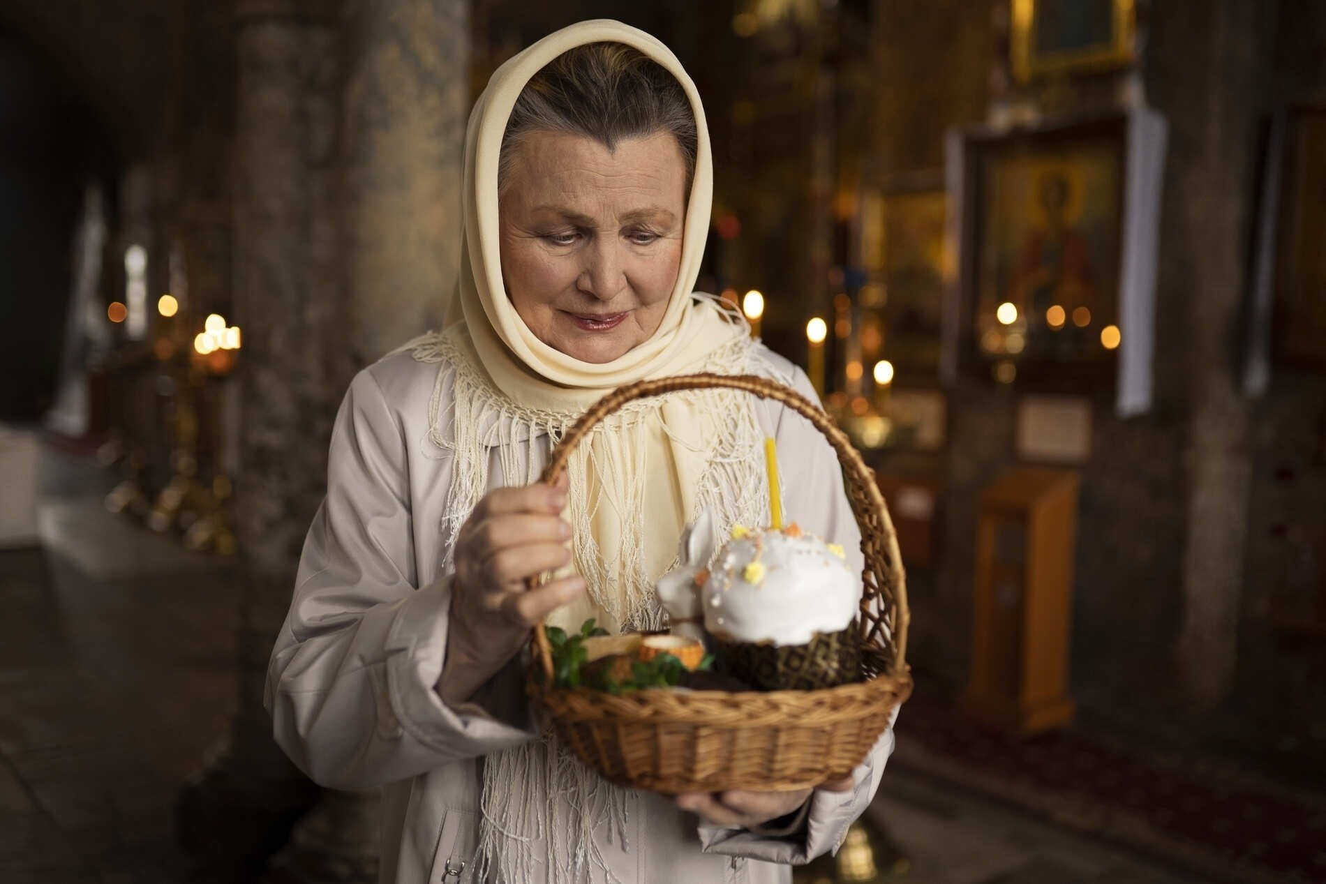 a woman holding a basket with a cake in it