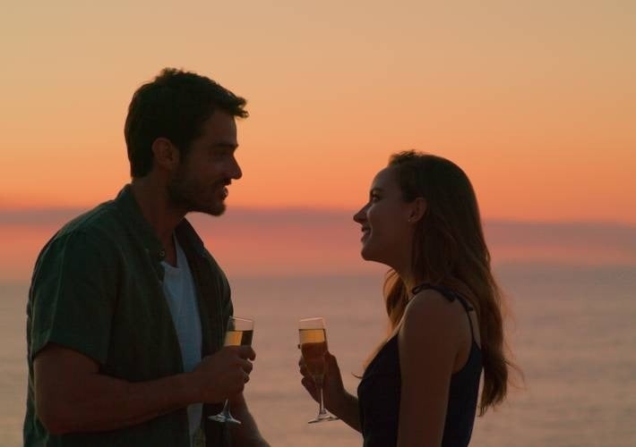 a man and a woman toasting with champagne glasses