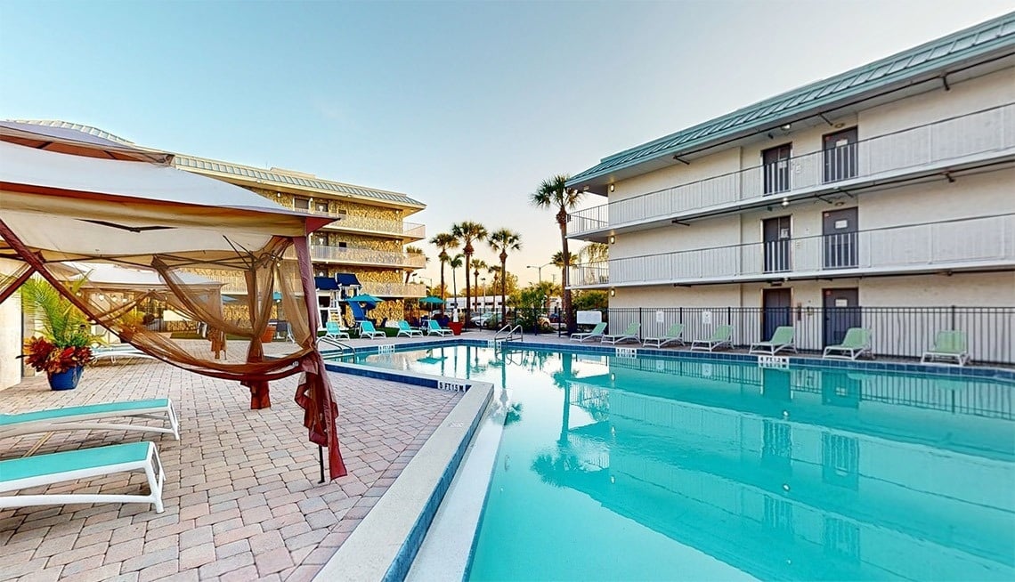 a large swimming pool in front of a hotel