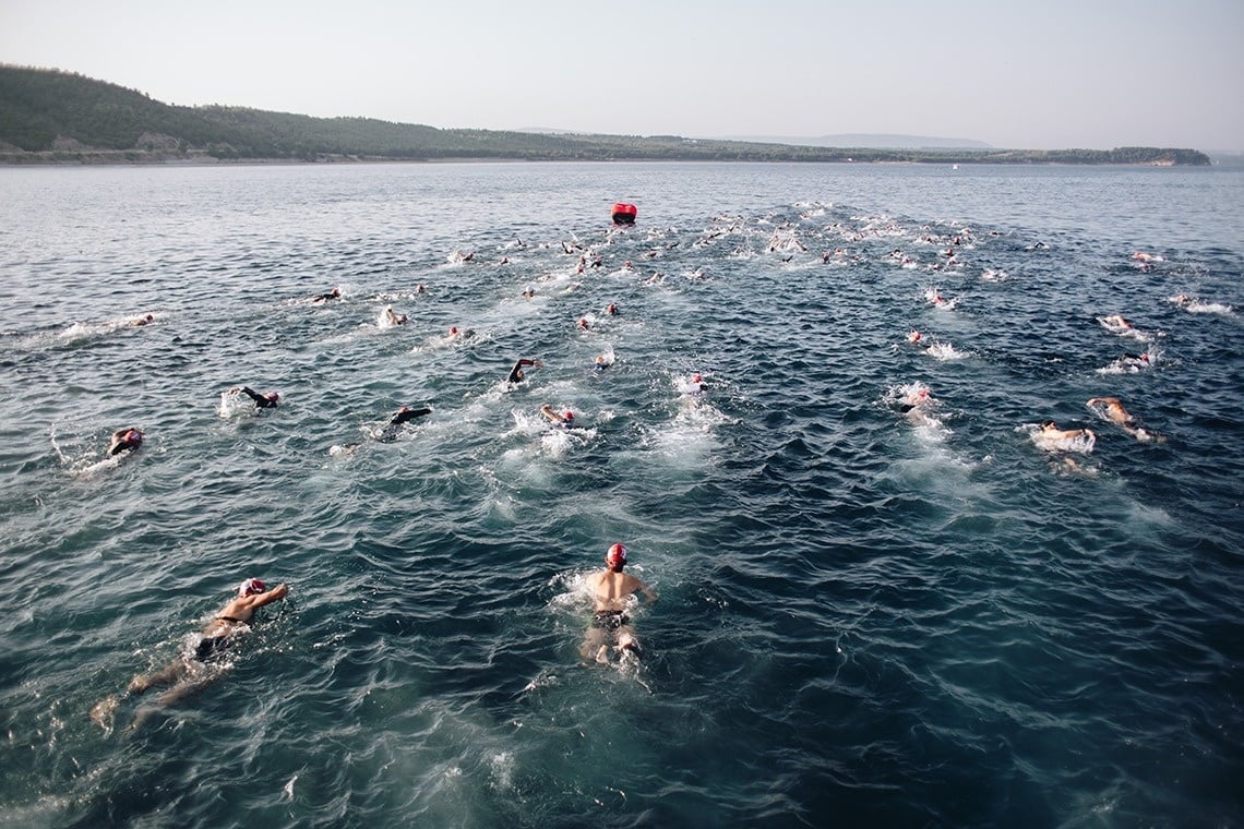 a large group of people are swimming in the ocean