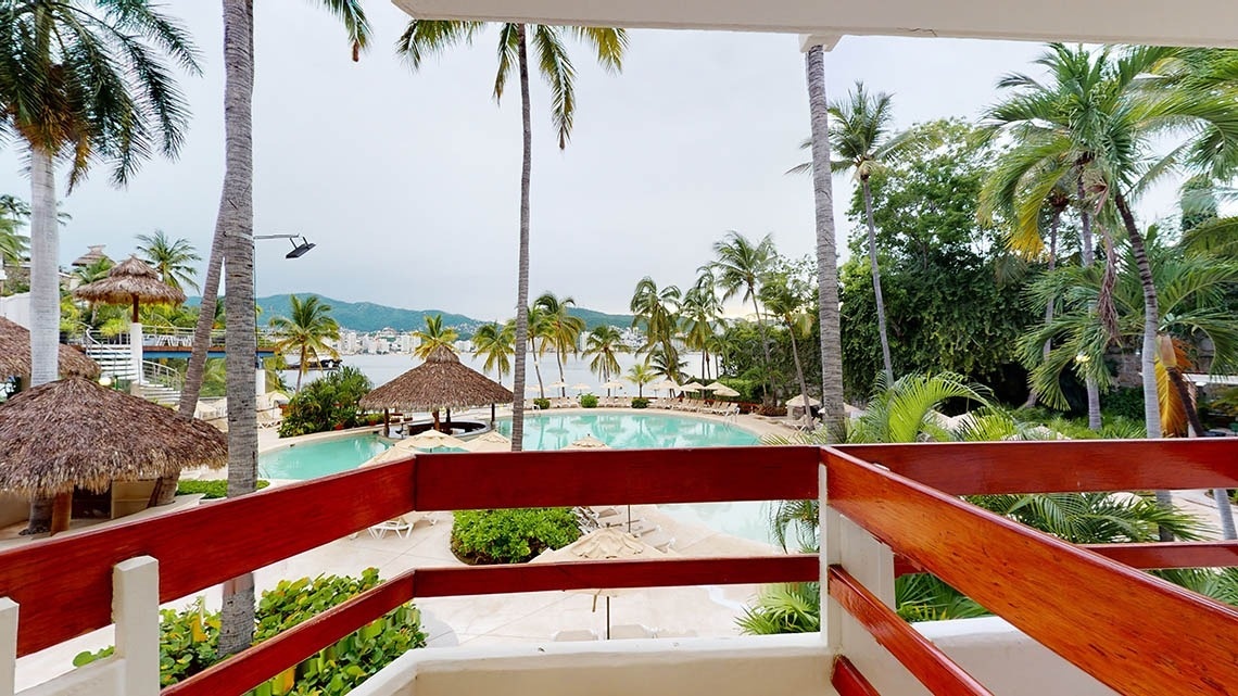 Vistas de uma piscina ao ar livre a partir de uma varanda no Park Royal Beach Acapulco Hotel