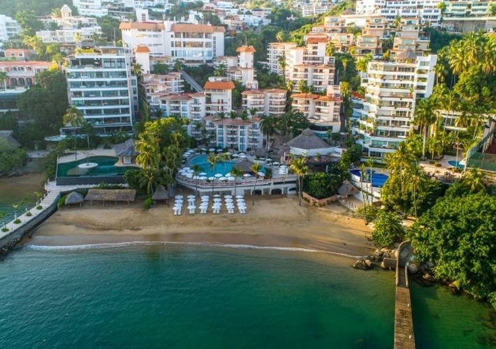 an aerial view of a beach resort with a large pool