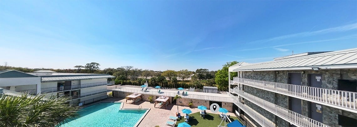 an aerial view of a hotel with a swimming pool