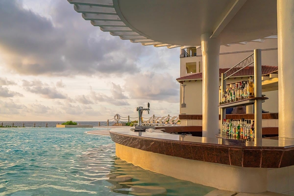 a swimming pool with a bar in the middle of it