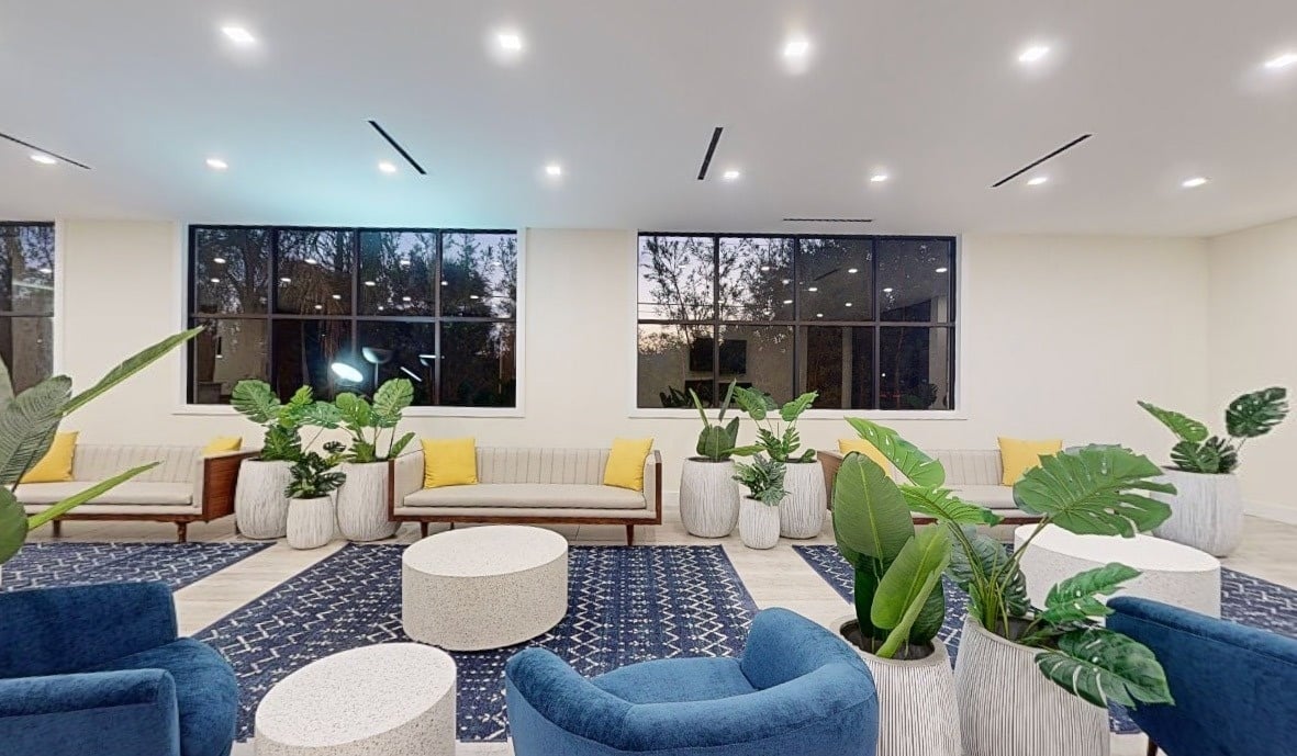 a living room filled with furniture and potted plants