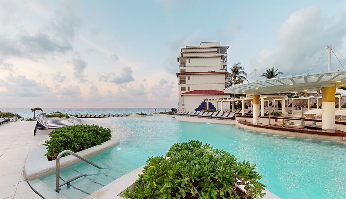 Couple in two-level pool with sea views at Park Royal Grand Cancun
