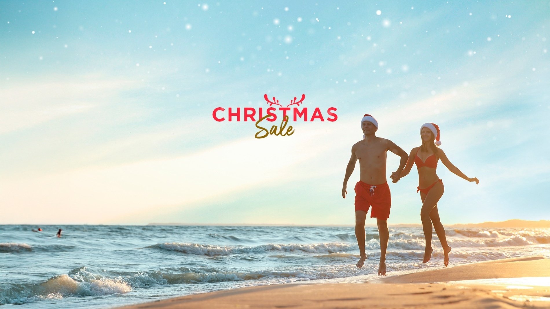 a man and woman walking on a beach with the words christmas sale above them