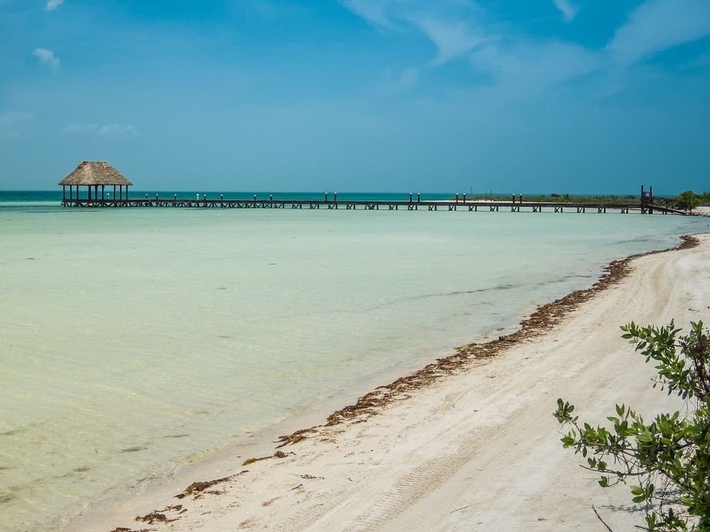 Image of Punta Cocos Beach next to the wooden pier