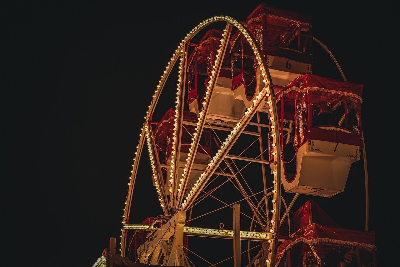 a christmas ferris wheel in an amusement park at night