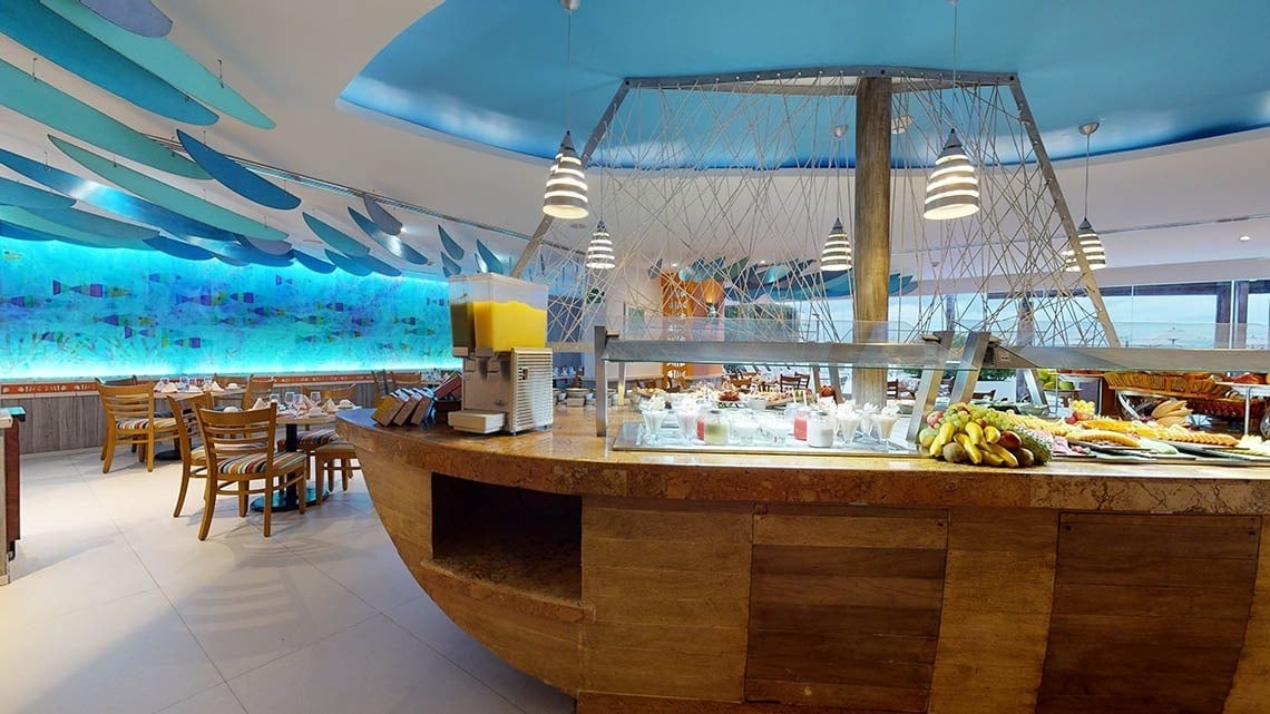 Decoration of the El Pescador restaurant, with a boat-shaped bar at the Hotel Grand Park Royal Puerto Vallarta
