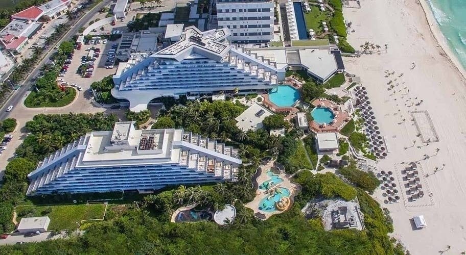 an aerial view of a pyramid shaped hotel near the beach