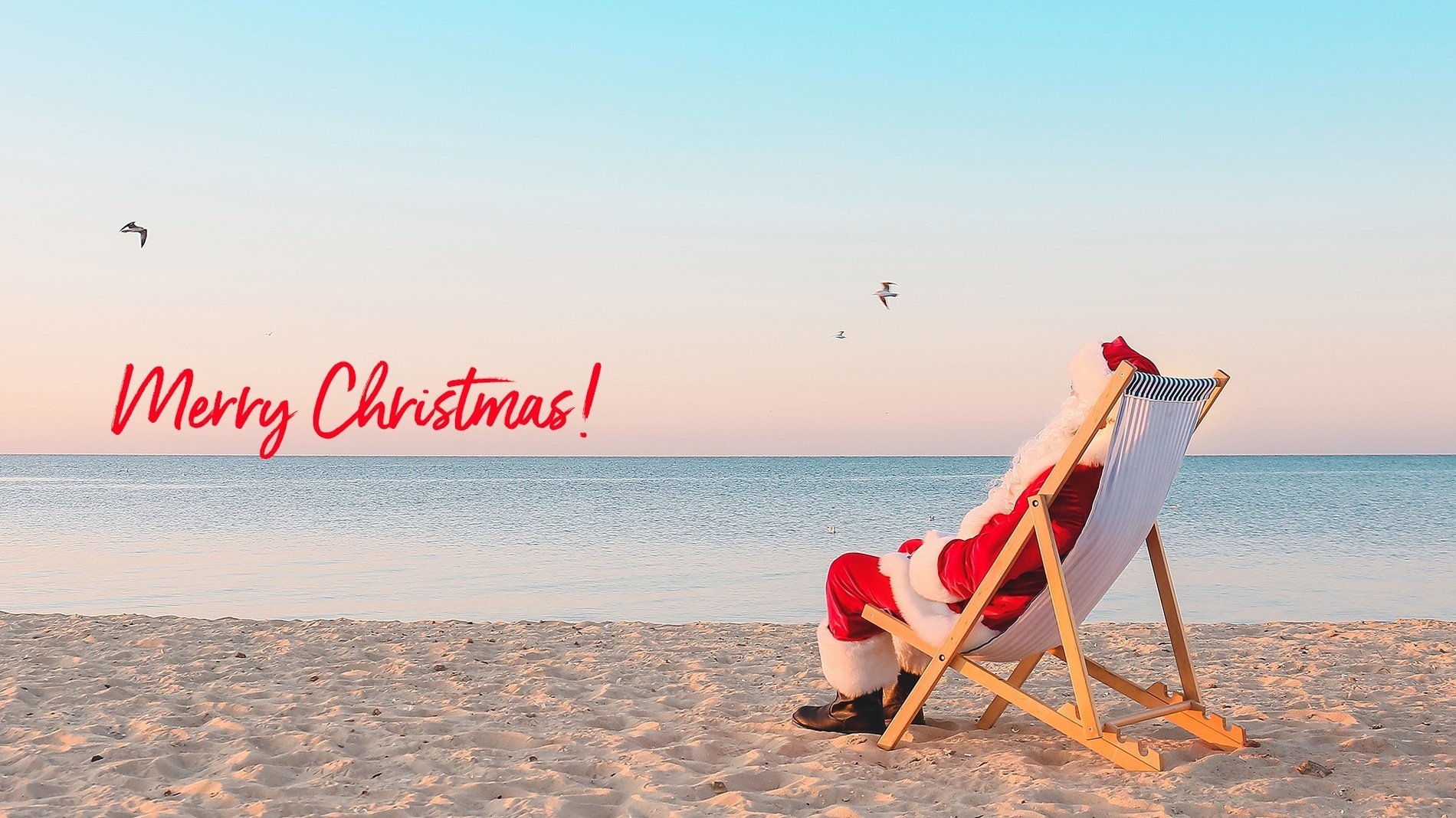 a man and woman walking on a beach with the words christmas sale above them