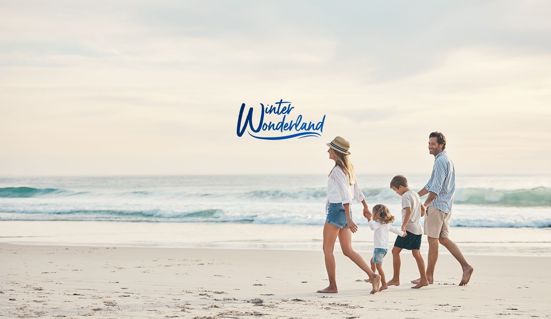 a man and woman walking on a beach with the words christmas sale above them