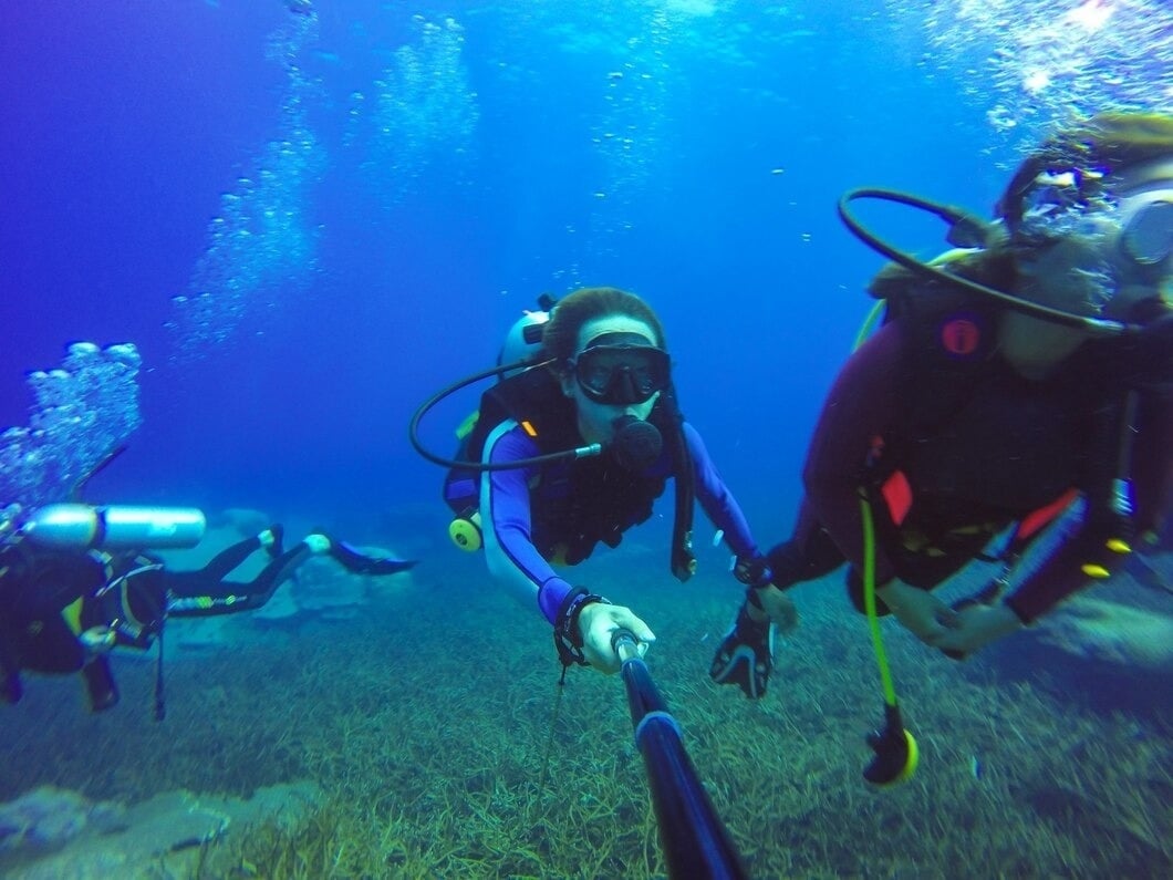 a group of scuba divers are swimming in the ocean