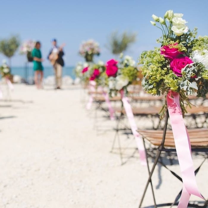 Floral decoration of chairs to celebrate a wedding on the beach of the Hotel Park Royal Beach Huatulco