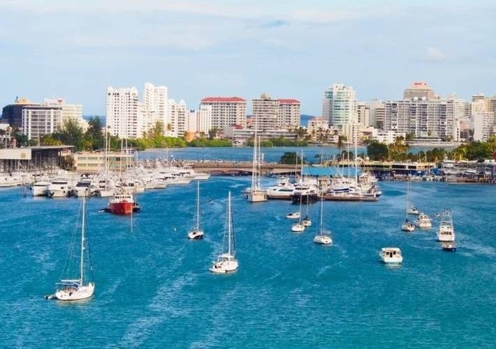 a harbor filled with boats and a city in the background