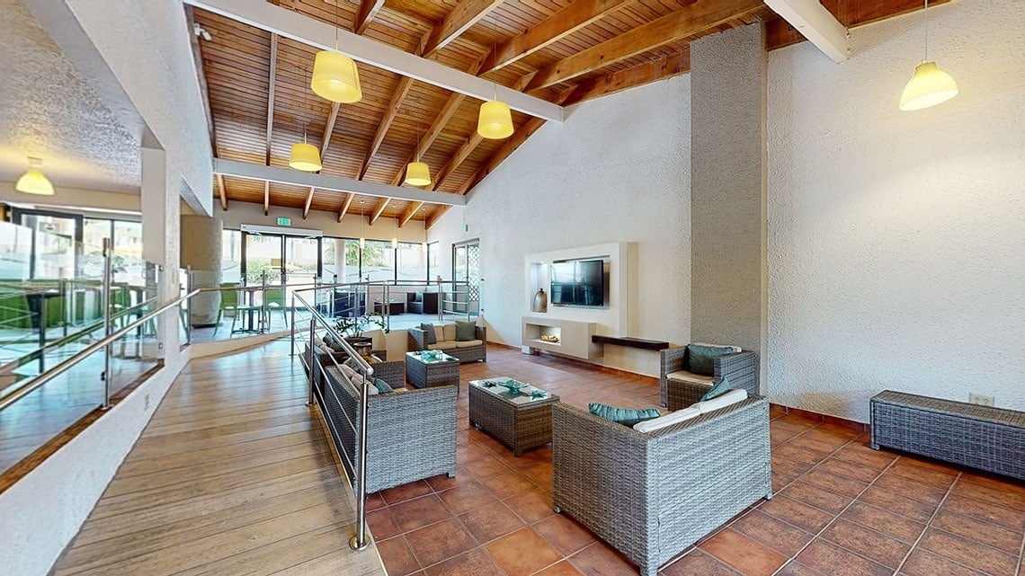 a living room with wicker furniture and a fireplace