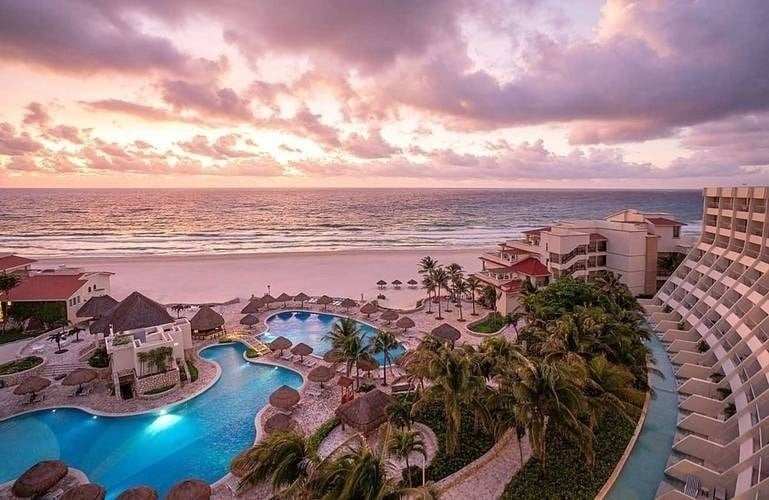 an aerial view of a resort with a large pool