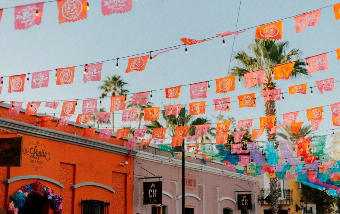 Banderines festivos sobre un hotel, evocando una atmósfera vibrante en Park Royal: Club Regina Los Cabos.