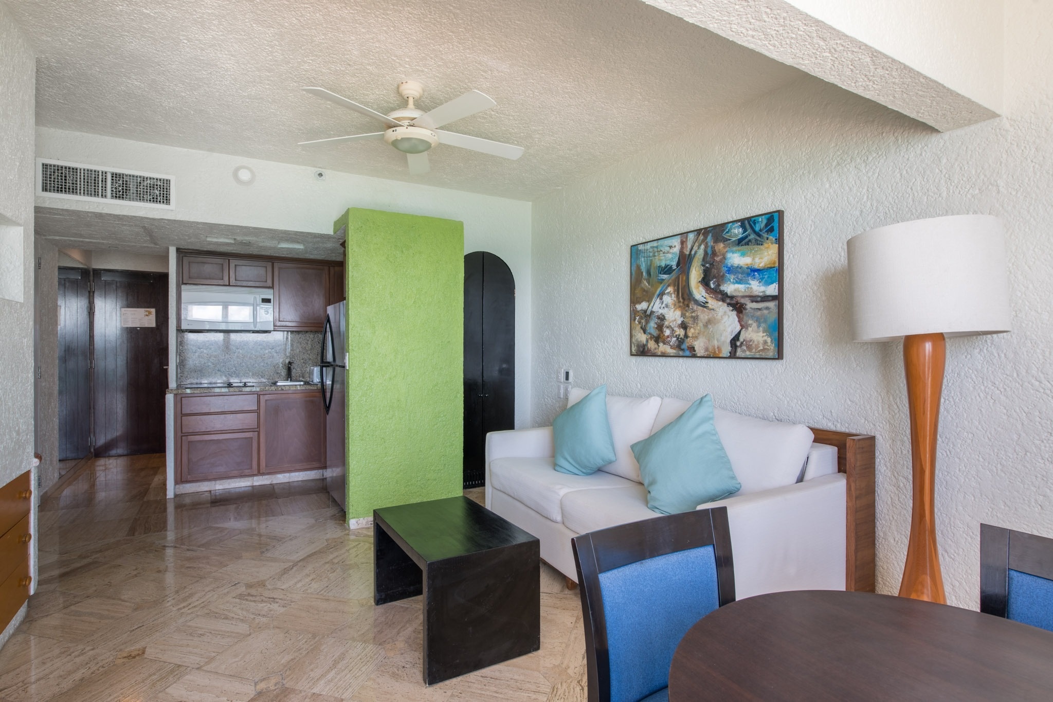 Bright living room at Park Royal: Club Regina Cancun featuring a white sofa and art.