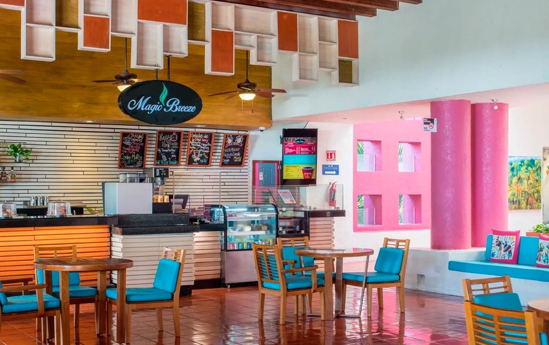 Cafetería en Park Royal: Club Regina Puerto Vallarta con mesas y sillas azules.
