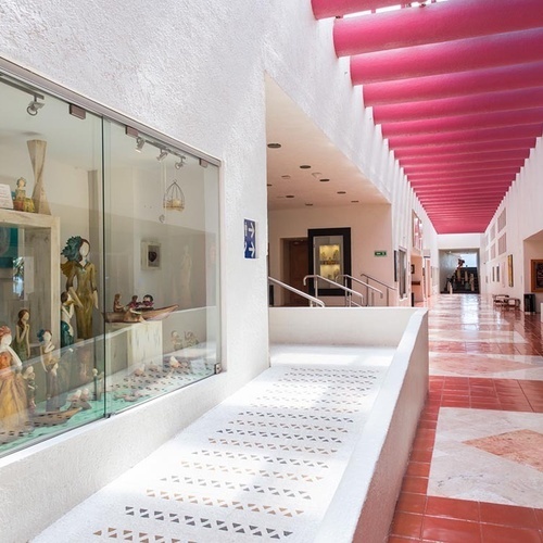 Pasillo exterior con exhibición de arte en Park Royal: Club Regina Puerto Vallarta.