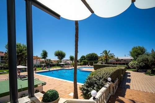Inviting outdoor swimming pool & gardens at Hotel Pato Amarillo, a 4-star hotel in Punta Umbría, Huelva.