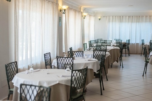Bright Pato Rojo Hotel dining room in Punta Umbria, Huelva, featuring set tables and natural light.