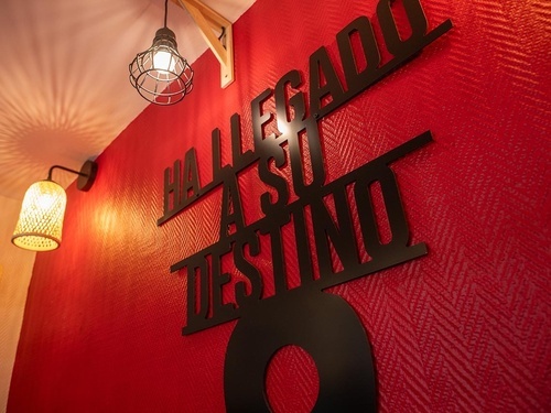 Welcoming wall decor and lighting at Pato Rojo Hotel, your destination in Punta Umbria, Huelva.