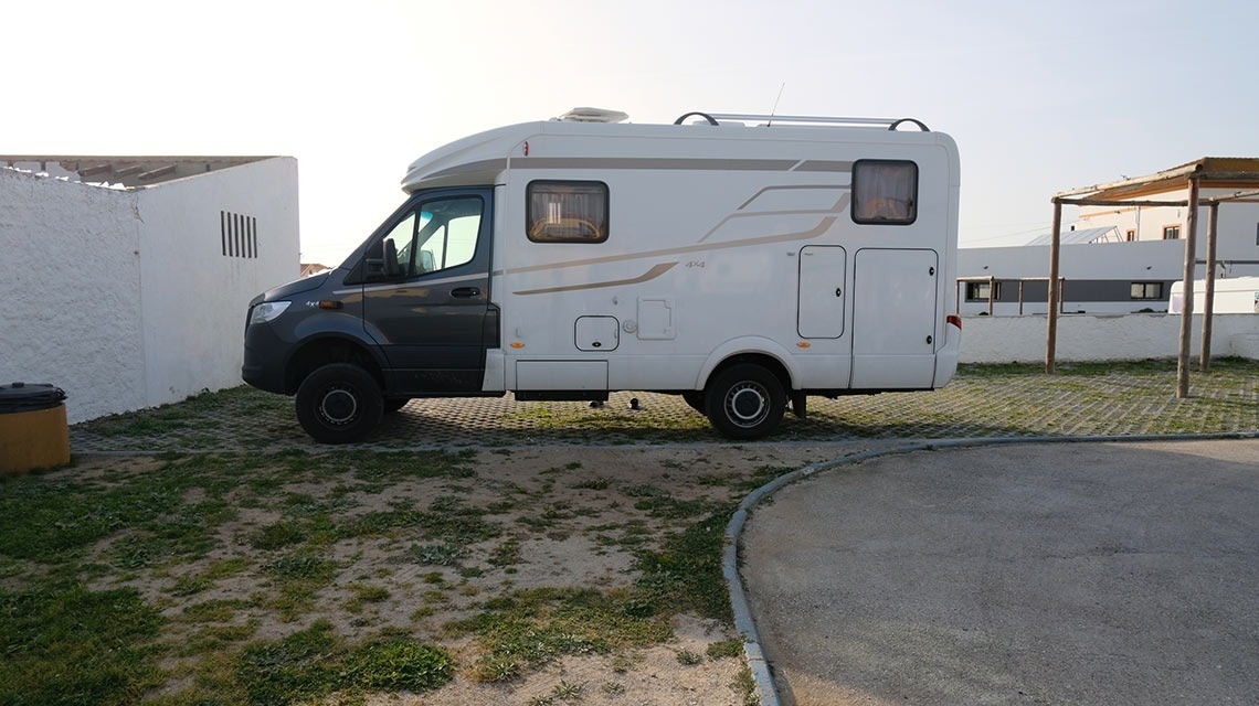a camper van is parked in a grassy area