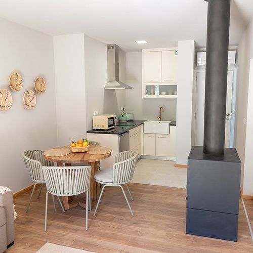 uma sala de estar com uma mesa de madeira e cadeiras