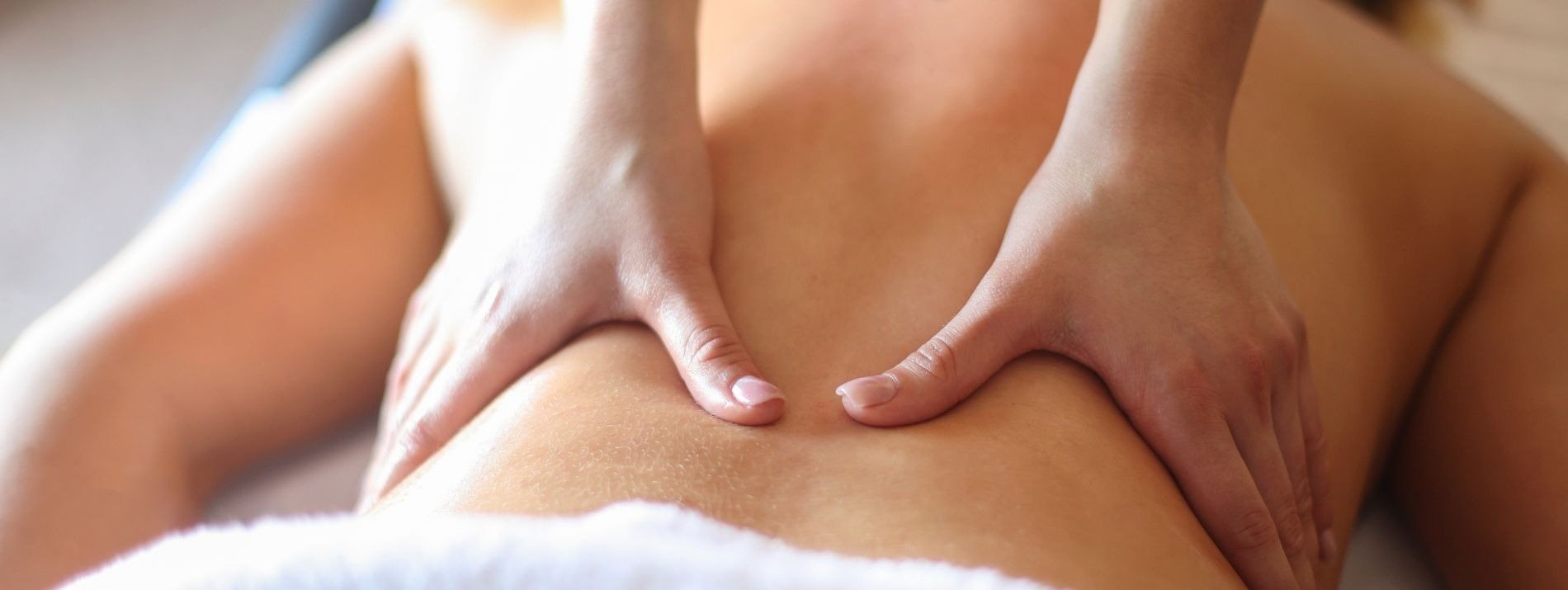 a woman is getting a massage with her hands on her back