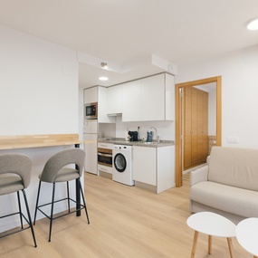 a kitchen with white cabinets and a washing machine